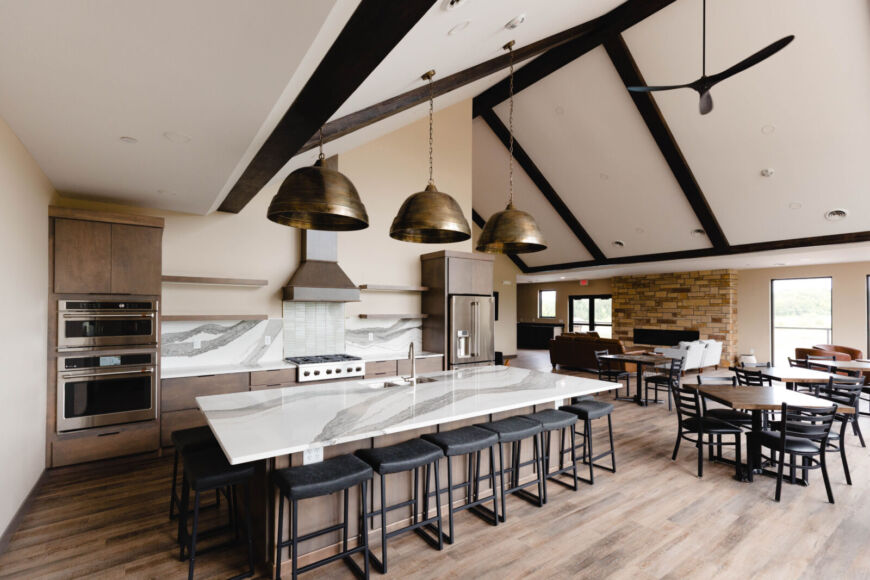 Siesta Hills clubhouse commercial kitchen with large island seating for resident events in Mankato Minnesota