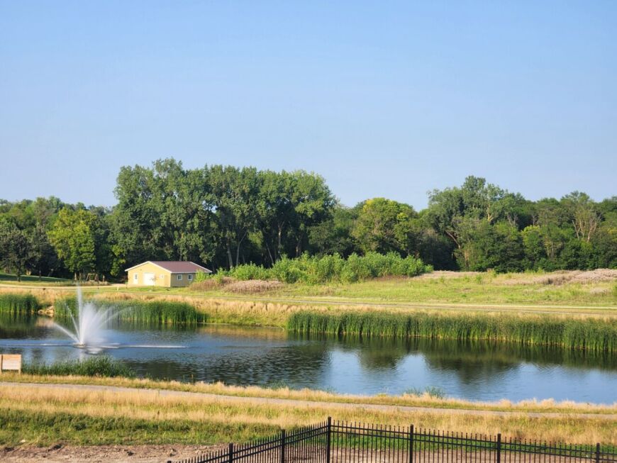 Scenic pond view at Siesta Hills in Mankato Minnesota with surrounding homes and natural landscape