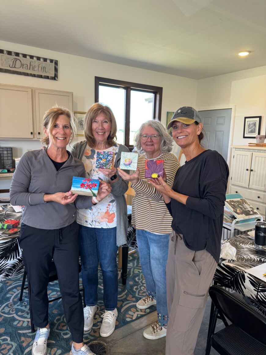 Residents showing paintings from a Siesta Hills art class in Mankato Minnesota