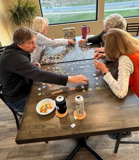Residents working on a puzzle together inside the Siesta Hills clubhouse in Mankato, Minnesota