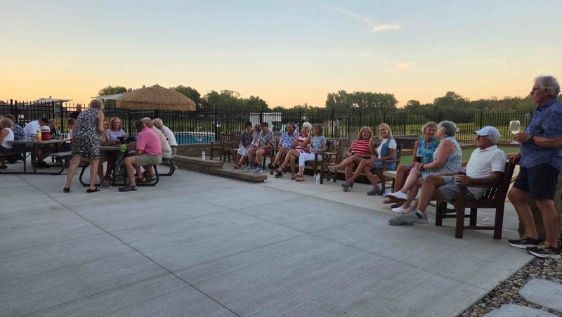 Residents enjoying a summer community gathering with live music, refreshments, and neighbors at Siesta Hills in Mankato, Minnesota.