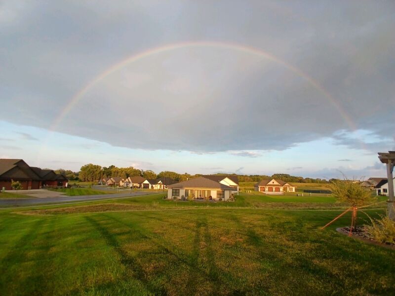 Rainbow over Siesta Hills community in Mankato Minnesota with homes and open green space