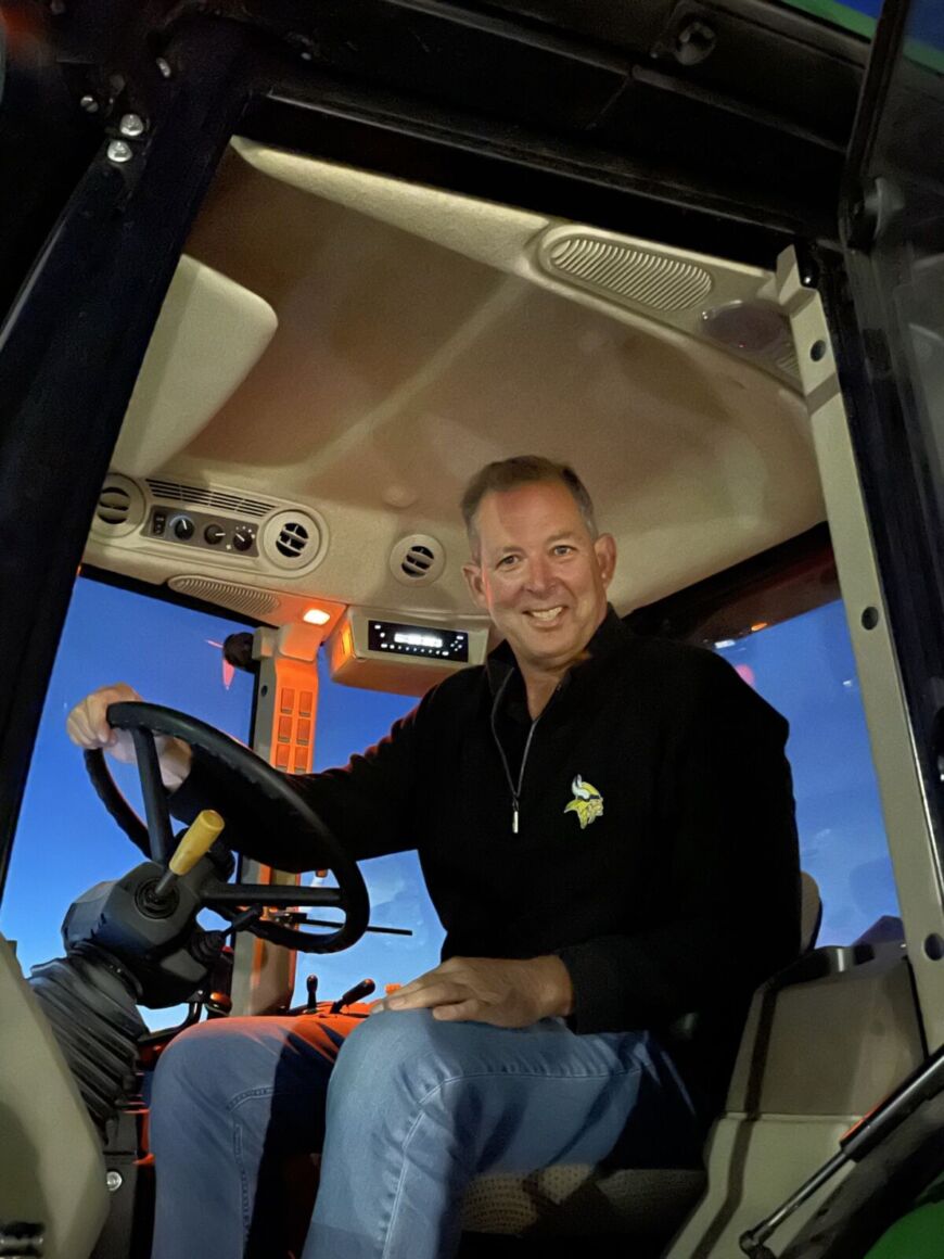 Resident driving hayride tractor at Siesta Hills community event in Mankato Minnesota