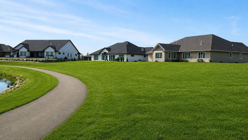 Walking trail through Siesta Hills with newly constructed homes in Mankato, Minnesota during the summer.