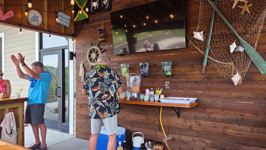 Residents enjoying the decorated Siesta Hills tiki bar during the 2026 Hawaiian luau