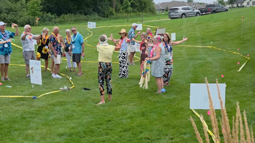 Siesta Hills residents participating in outdoor yard games during the 2026 Hawaiian luau