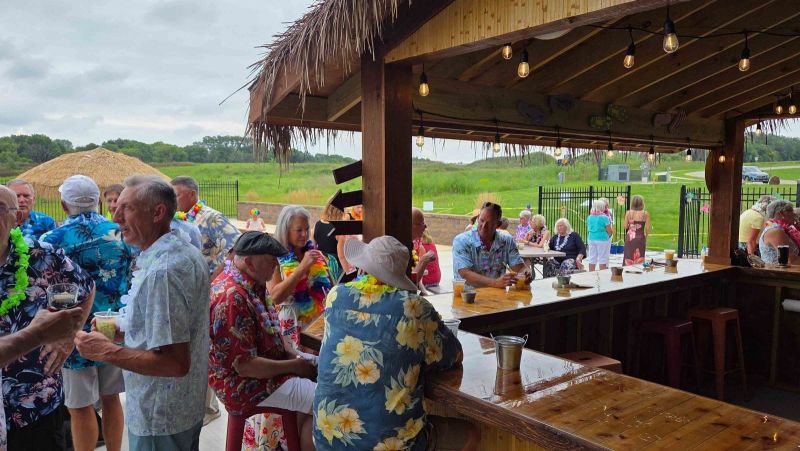 Siesta Hills neighbors gathering at the tiki bar and clubhouse patio during a Hawaiian luau